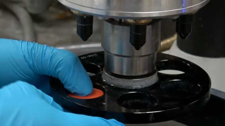 Gloved hands using a CNC machine